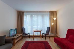 un soggiorno con un divano e un tavolo con sedie di Apartments Zentrum Brühl a Lipsia