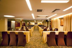 a conference room with long tables and chairs at Grand Tropic Suites Hotel in Jakarta +48 photos