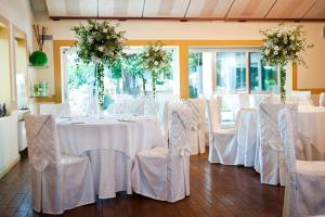 una stanza con tavoli e sedie con tovaglie bianche di Ca' delle Rose a Castelfranco Veneto