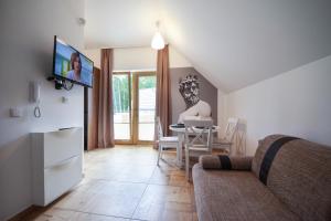 a living room with a couch and a table at Villa Arkadia MARE in Łukęcin