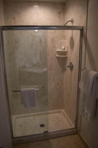 a bathroom with a shower, toilet and sink at Munras Inn in Monterey