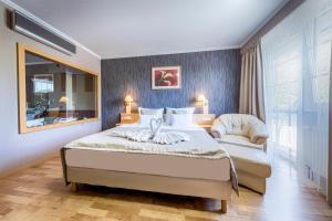 Posteľ alebo postele v izbe v ubytovaní MenDan Magic Spa & Wellness Hotel