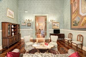 a living room with a table and chairs at Arthouse Lady Marys Tribunali Luxury Suite in Naples