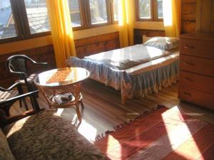 a bedroom with two beds and a table and chairs at u Piwowara in Kościelisko