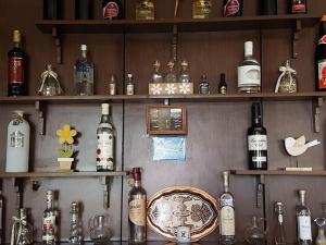 a bar with lots of bottles of alcohol on shelves at Kekrops Hotel in Loutra Edipsou