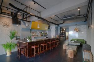 a restaurant with a bar with stools at M House in Hualien City