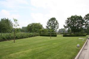 a large field of grass with trees and bushes at Biznis Hotel in Lokeren