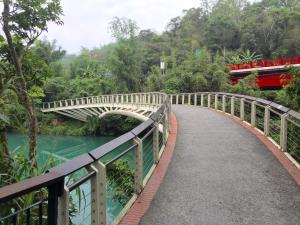 a bridge over a river with a bus at Sun Fog Hotel in Yuchi