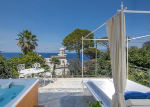 a beach with a balcony overlooking the ocean at Luxury Villa Excelsior Parco in Capri