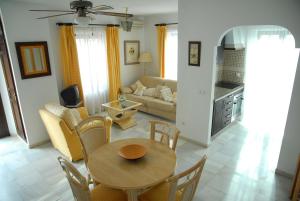 a living room with a table and a couch at Mijas Pueblo Apartment in Mijas