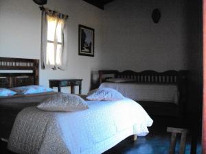 Gulta vai gultas numurā naktsmītnē Pousada Encantos do Cerrado
