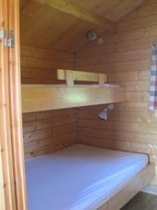 a inside of a sauna with a bed in it at Höfn Cottages in Höfn