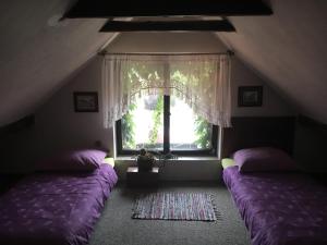 a bedroom with two beds in front of a window at Penzion Prezident in Soběraz +65 photos