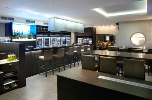 a bar in a restaurant with chairs and tables at Biznis Hotel in Lokeren