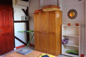 a wooden cabinet in the corner of a room at Gites Les Sandragons in Saint-Claude