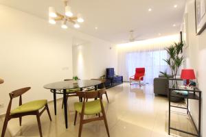 a living room with a dining room table and chairs at Vista Horizon Melaka in Malacca