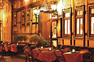 a restaurant with tables and chairs in a building at Hotel Zum Kanzler in Stolberg