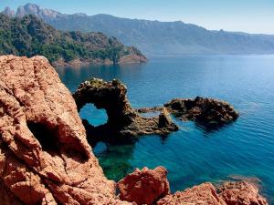 a large body of water with rocks in the water at Residence ACQUA LINDA Porticcio in Porticcio