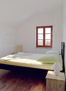 a large bed in a room with a window at Mala Villa- private heated pool in Novalja