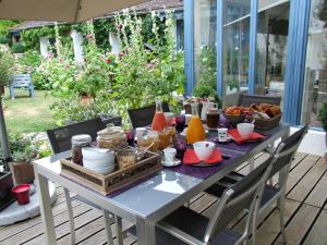 a table with food on it on a patio at Les Glycines in Ury