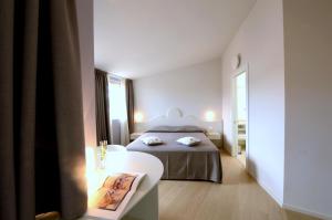 Postel nebo postele na pokoji v ubytování Aromi Piccolo Hotel