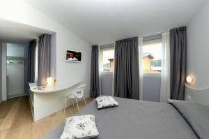 Postel nebo postele na pokoji v ubytování Aromi Piccolo Hotel