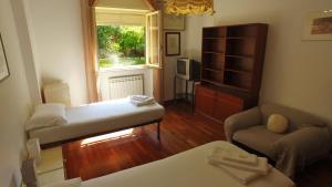 a living room with a bed and a couch and a window at Camping Jonio in Catania