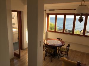 comedor con mesa y vistas al océano en Villa Maria 2, en Giardini Naxos