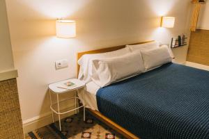 a bedroom with a bed and a side table at Hotel Casa Bonay & Spa in Barcelona