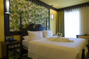 מיטה או מיטות בחדר ב-Villa Delisle Hôtel & Spa
