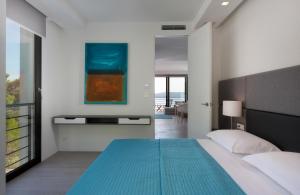 a bedroom with a large bed with a blue blanket at Soho Apartments Brela in Brela +19 photos