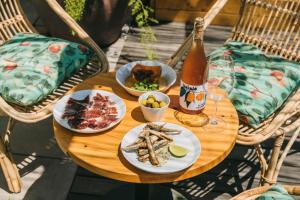 a table with plates of food and a bottle of beer at Hotel Casa Bonay & Spa in Barcelona
