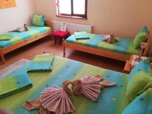 a room with two beds and two chairs at Villa Bulgarka in Divchovoto