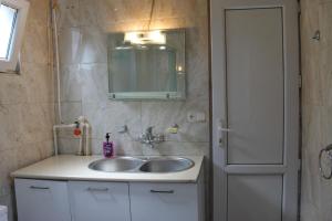 a bathroom with a sink and a mirror at Tbilisi Heart in Tbilisi City +8 photos
