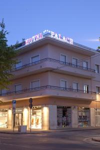 a building with a sign on top of it at Palace Hotel in Civitanova Marche
