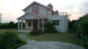 a white house with a red turret at Aakriti NS71 in Bhopal