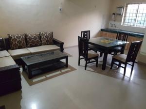 a living room with a couch and a table at Aakriti NS71 in Bhopal