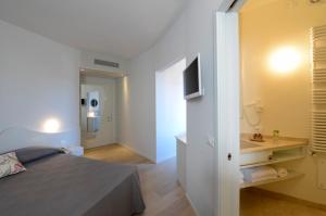Postel nebo postele na pokoji v ubytování Aromi Piccolo Hotel
