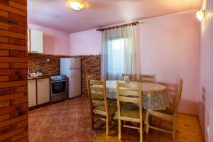 una cucina e una sala da pranzo con tavolo e sedie di Guesthouse Wolf a Žabljak