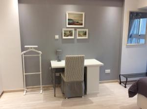 a room with a desk and a chair on a wall at The Central Suites in Nicosia