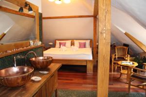 a bedroom with a bed and two sinks in a room at Pension U Hastrmana in Prague
