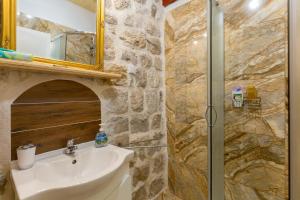 a bathroom with a sink and a shower at Juliette's Palace Studios in Dubrovnik +61 photos