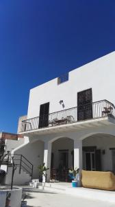a white house with a balcony on top of it at Residenza al Gelso in Marsala