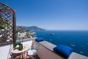 a balcony with a table and chairs and the ocean at Hotel Villa Felice Relais in Amalfi