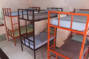a room with three bunk beds in a room at Hostel Aventura in Alto Paraíso de Goiás