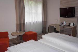 Postel nebo postele na pokoji v ubytování Hotel Kastanienhof