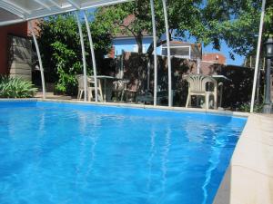 a swimming pool with blue water in a house at Gîte la Ferme in Mutzig