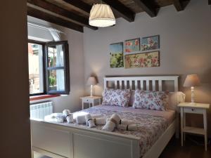 a bedroom with a bed with two tables and two windows at Apartamentos San Antonio de Garabandal in San Sebastián de Garabandal