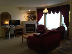 a living room with a couch and a fireplace at Western Budget Motel #1 Grande Prairie in Grande Prairie