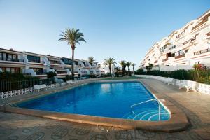 a swimming pool in front of some apartment buildings at Costa del Silencio Apartment in Costa Del Silencio